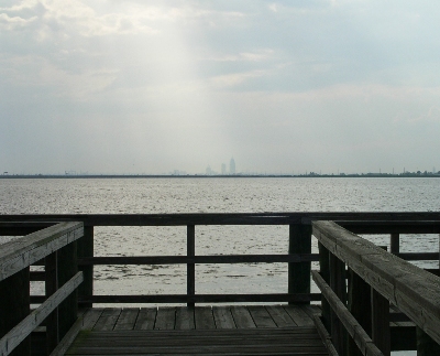 [Tall buildings in the far distance across a wide expanse of water.]